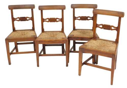 A set of four Regency oak and rush seated dining chairs, with bar backs, raised on square legs...