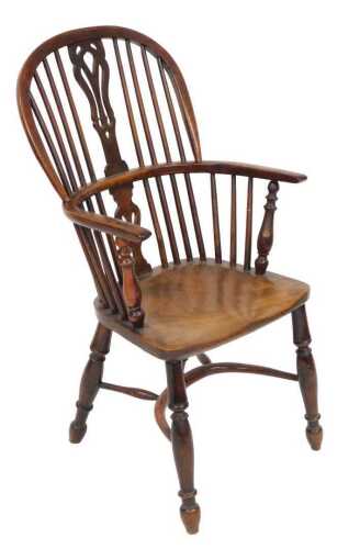 A 19thC yew and elm Windsor chair, with a pierced vase shaped splat, and solid saddle seat,...