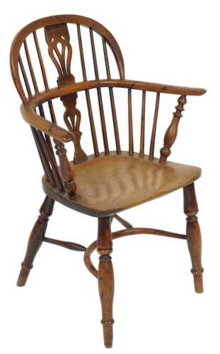 A 19thC yew and elm Windsor chair, with a pierced carved vase shaped splat, and a solid saddle...