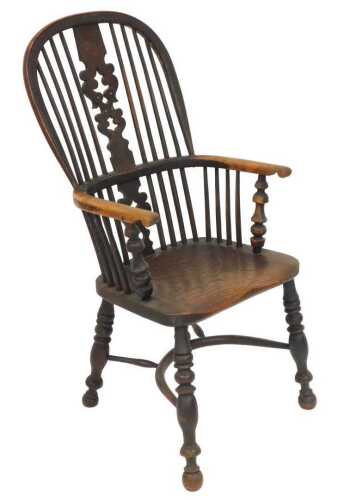 A 19thC yew and elm Windsor chair, with a carved vase shaped splat, and solid saddle seat,...