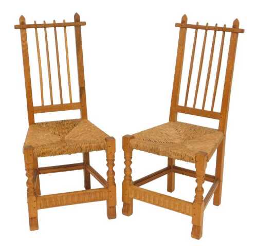 A pair of Rupert or Nigel Griffiths oak and rush seated monastic chairs, 46cm wide.