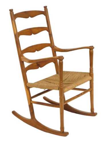 A yew wood ladderback rocking chair, with a woven rush seat, 57cm wide.