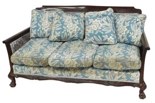 An early 20thC mahogany and cane bergere two seater sofa, with loose cushions, 153cm wide.