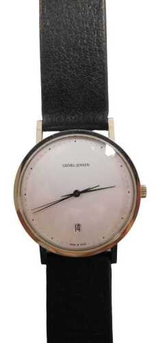 A Georg Jensen wristwatch, designed by Henning Koppel, with a white dial and date aperture, in a...