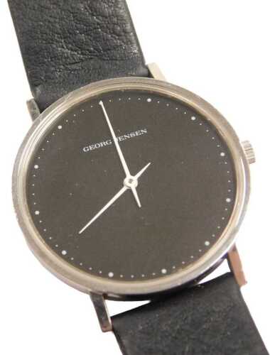 A Georg Jensen wristwatch, designed by Henning Koppel with a black dial, design 321, in a...