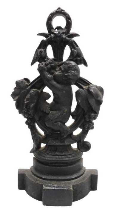 A Victorian cast iron door stop, modelled with a putto and vines, 42cm high.