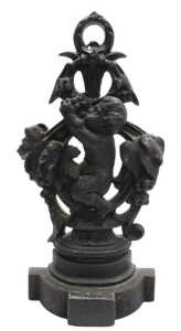 A Victorian cast iron door stop, modelled with a putto and vines, 42cm high.