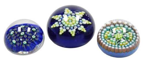 A Perthshire glass paperweight, with spiral twists and millefiori canes, a further Perthshire...