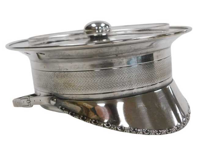 A WWI period silver plate and cut glass dish and cover, formed as a officer's peaked cap, with...