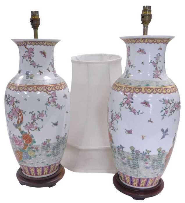 A pair of late 20thC Chinese famille rose porcelain table lamps, decorated with birds, flowers,...