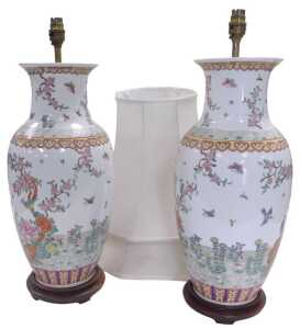 A pair of late 20thC Chinese famille rose porcelain table lamps, decorated with birds, flowers,...