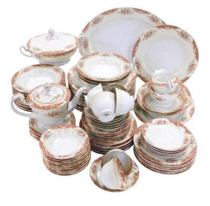 A Noritake porcelain part dinner and tea set, printed with flowers, on an ivory ground,...