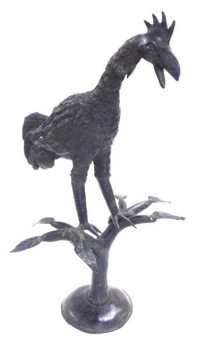 A cast iron figure of a cockerel, modelled perched on a divided tree trunk, and a circular base,...