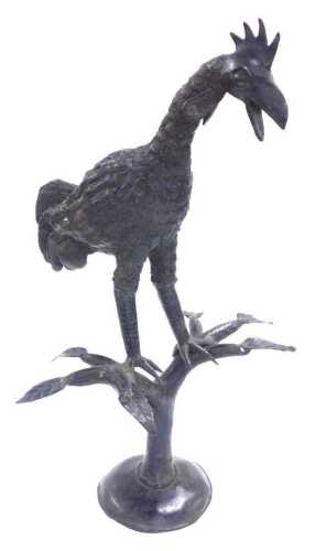 A cast iron figure of a cockerel, modelled perched on a divided tree trunk, and a circular base,...