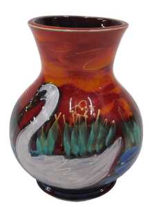 A 20thC Anita Harris pottery swan vase, of bulbous form on a circular foot, hand painted in red,...