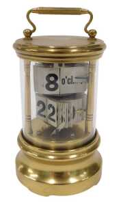 An early 20thC Plato style brass cased ticket desk jump hour clock, of cylindrical form, with...