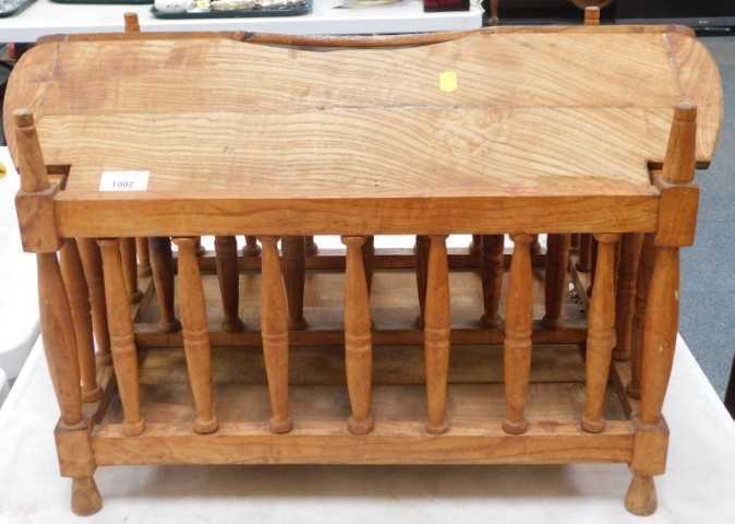 An elm Canterbury, with loose top, spindle turned gallery, on turned feet, 61cm wide.
