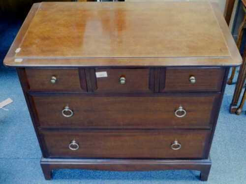 A small Stag Minstrel mahogany chest of drawers, with three short and two long drawers, on...