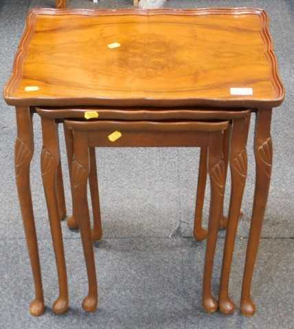 A nest of three walnut tables, on cabriole legs with pad feet, the largest 50cm wide.