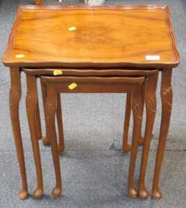 A nest of three walnut tables, on cabriole legs with pad feet, the largest 50cm wide.