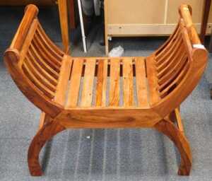 A hardwood X shaped stool, with slatted seat and sides, 69cm wide.