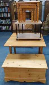 An oak drop leaf table, nest of three tables, pine blanket box, and a TV stand. (4)