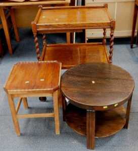 A 1930s oak circular two tier coffee table, a trolley with spirally twisted supports, and a...