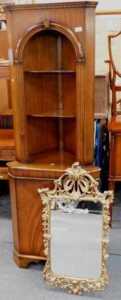 A walnut standing corner cabinet, the open top with two shelves above a door, 65cm wide, and a...