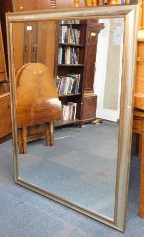 A silvered rectangular wall mirror, with bevelled plate, 136cm high, 105cm wide.