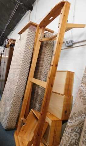 A pine single bed, with caned headboard, and stow away bed, with two mattresses. 
The upholstery...
