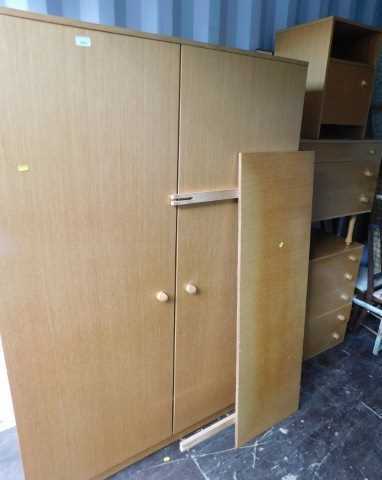 A 1970s Avalon teak bedroom suite, comprising double wardrobe, headboard, chest of four drawers,...
