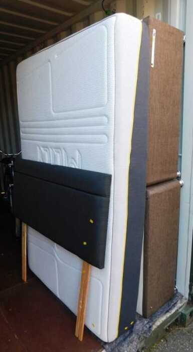 A double divan bed, with headboard and a M Lily Premier 2000 mattress.