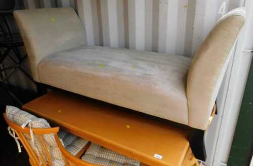 A beige upholstered double ended scroll arms chaise longue bench, with dark wooden tapering legs.