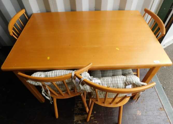 A beech kitchen table, of plain form, and four Ercol style kitchen chairs with spindle turned...