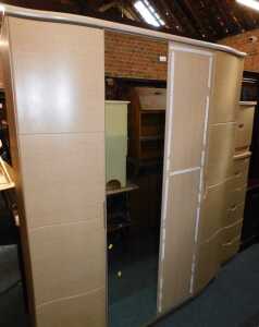 An Alstons Synergy bedroom suite, comprising a four-door wardrobe with a mirrored centre section,...