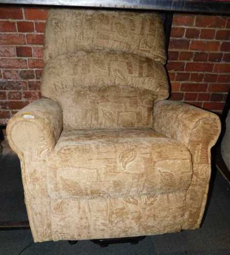 A rise and fall electrically operated armchair, upholstered in a light brown fabric with foliate...