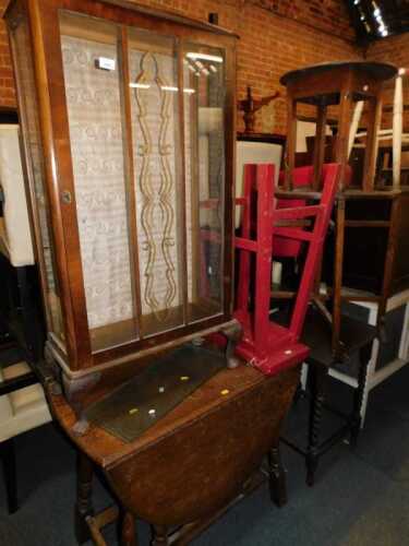 Furniture comprising a mid 20thC display cabinet, with glazed door, over short cabriole supports,...