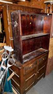 A dark oak dresser, with a plate rack over two drawers above two cupboard doors, raised on...