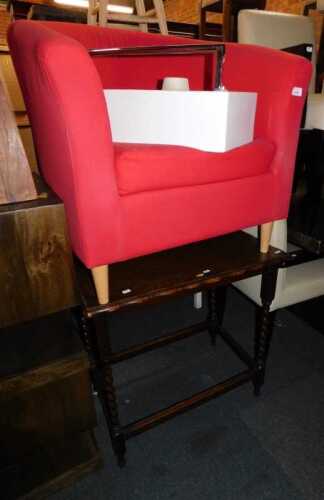 A red upholstered tub chair, a square topped occasional table on barley twist supports joined by...