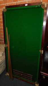 A quarter size tabletop snooker table, with cues and scoreboard.