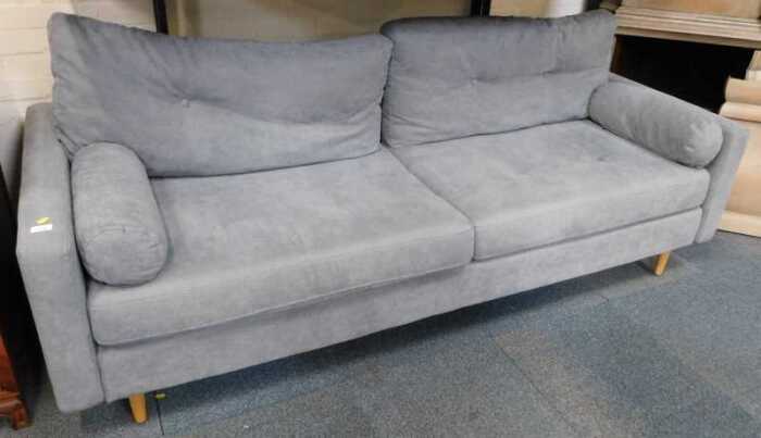 A contemporary grey upholstered three-seater sofa, raised on oak cylindrical tapering legs,...