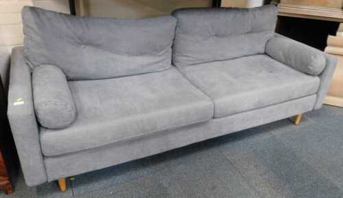 A contemporary grey upholstered three-seater sofa, raised on oak cylindrical tapering legs,...
