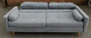 A contemporary grey upholstered three-seater sofa, raised on oak cylindrical tapering legs,... - 3