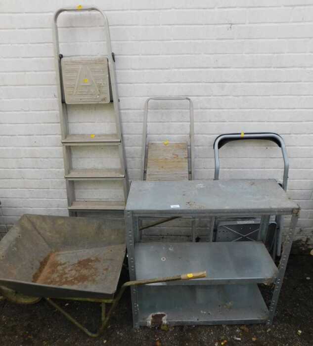 A galvanised three tier shelf, a wheelbarrow, three sets of step ladders. (5)