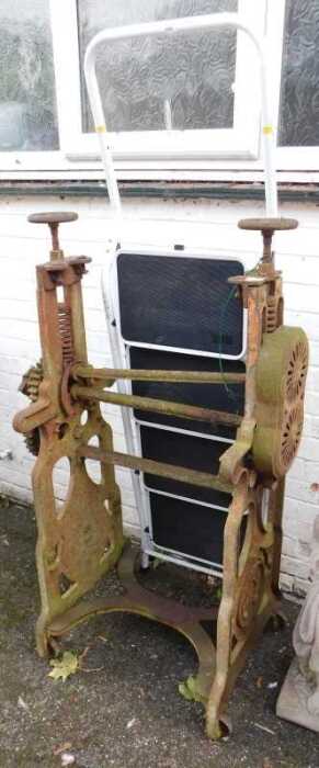 A cast iron mangle with horseshoe motif (AF), and a pair of steps, finished in white. (2)