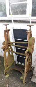 A cast iron mangle with horseshoe motif (AF), and a pair of steps, finished in white. (2)
