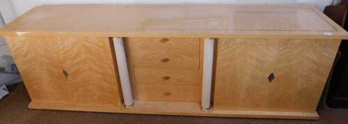 An Italian birdseye maple side cabinet, having a rectangular top with silvered metallic...