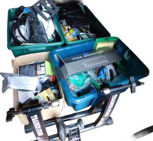Various tools, including a hosepipe, a Piranha stapler, etc, and a bicycle trainer. (a quantity)...