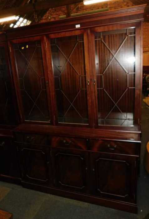 A Georgian style mahogany veneered display cabinet, of three astragal glazed doors over three...