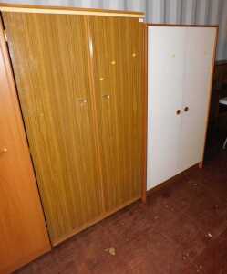 A teak and rosewood laminate double wardrobe, a further two door wardobe, and a table top safe. (3)